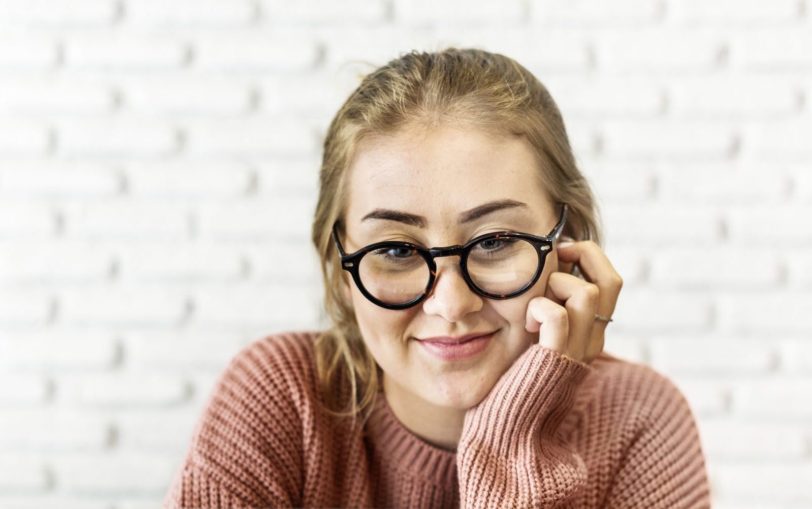 Cheerful young woman using laptop