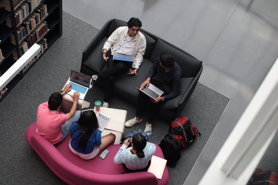 A group of diverse students using laptop